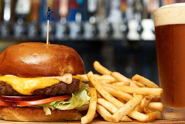 A cheeseburger, fries and a beer.