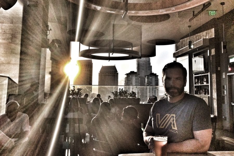 A handsome, young man drinking a beer.